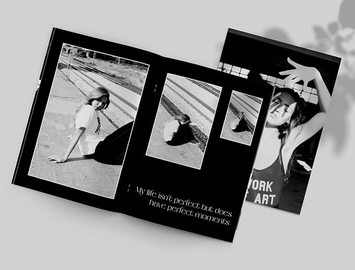 Fotolibro Ambition abierto con fotografías en blanco y negro de mujeres